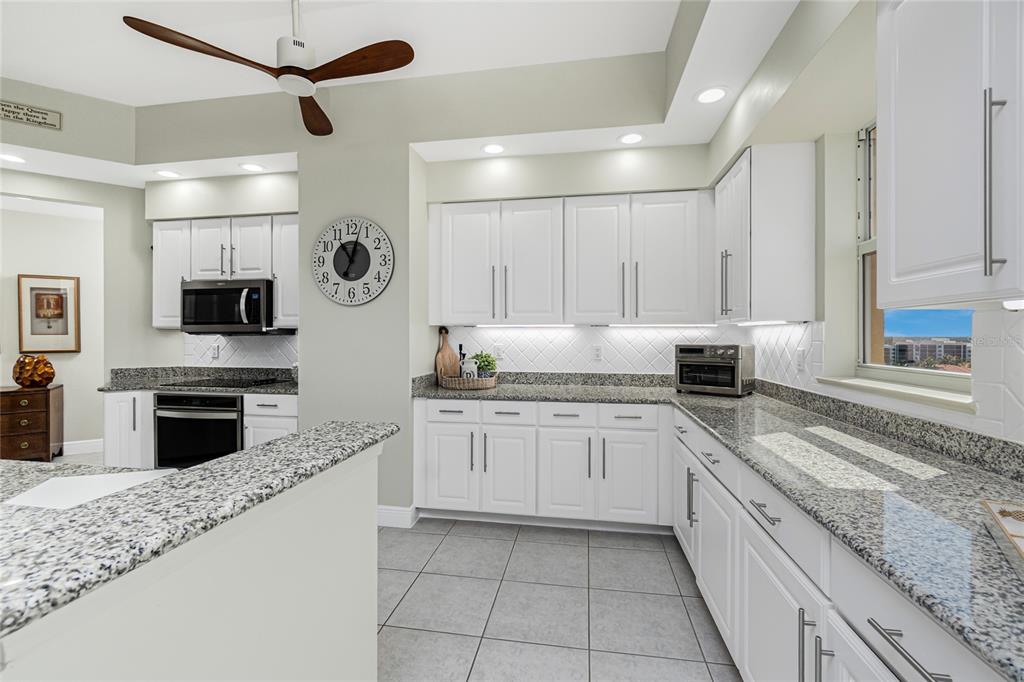 3313 Sunset Key Circle, Unit 701 Punta Gorda, FL 33955 - Photo 16 of 57 a kitchen with granite countertop cabinets stainless steel appliances and a counter space