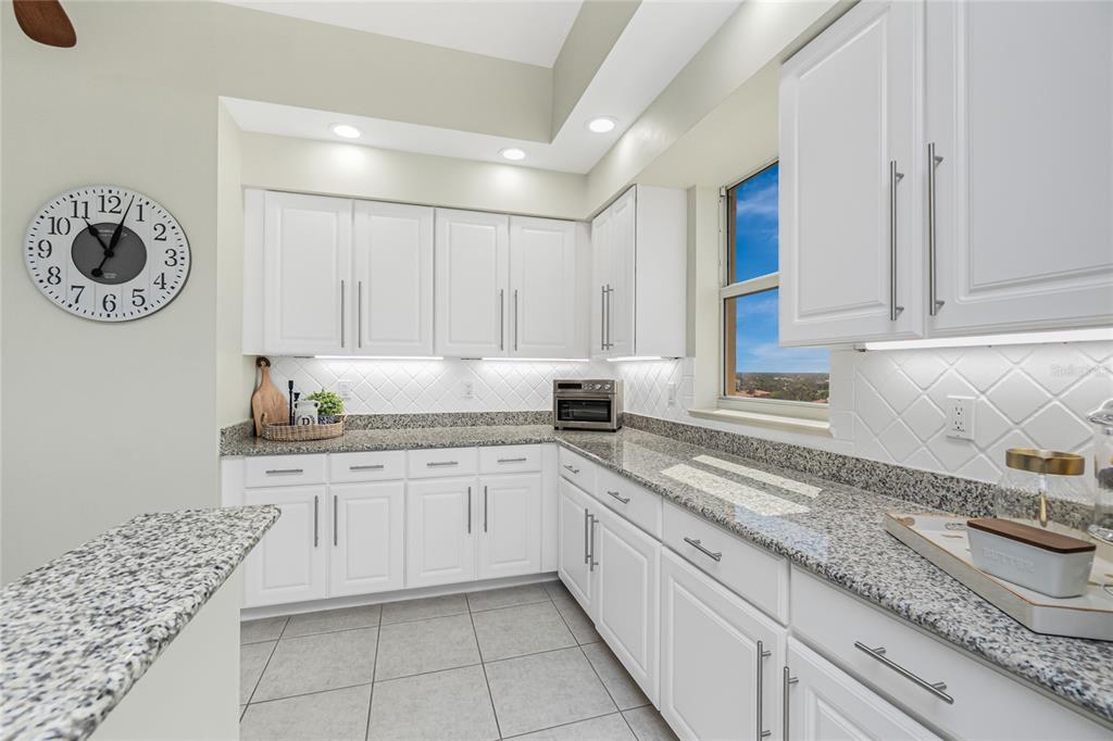 3313 Sunset Key Circle, Unit 701 Punta Gorda, FL 33955 - Photo 17 of 57 a kitchen with granite countertop white cabinets and a sink