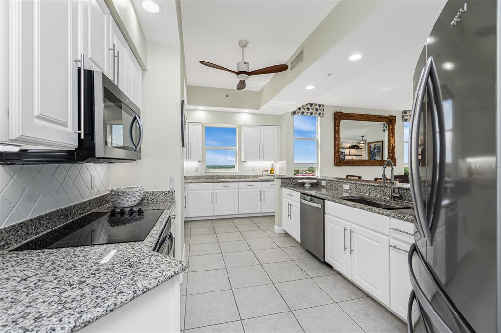3313 Sunset Key Circle, Unit 701 Punta Gorda, FL 33955 - Photo 22 of 57 a kitchen with stainless steel appliances granite countertop a sink stove and refrigerator