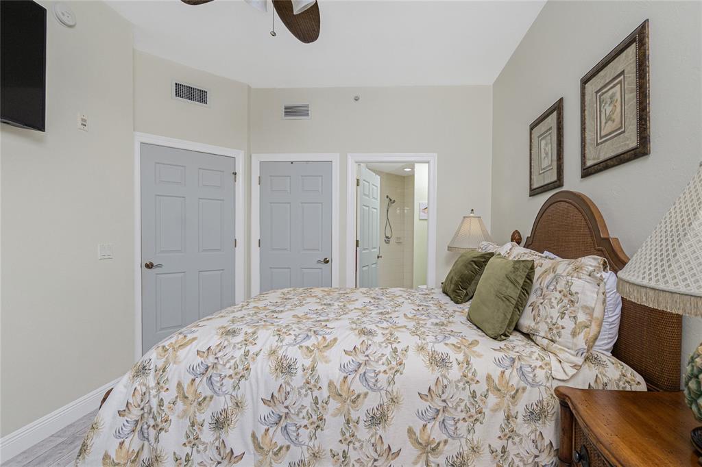 3313 Sunset Key Circle, Unit 701 Punta Gorda, FL 33955 - Photo 26 of 57 a bedroom with a bed and a lamp on dresser