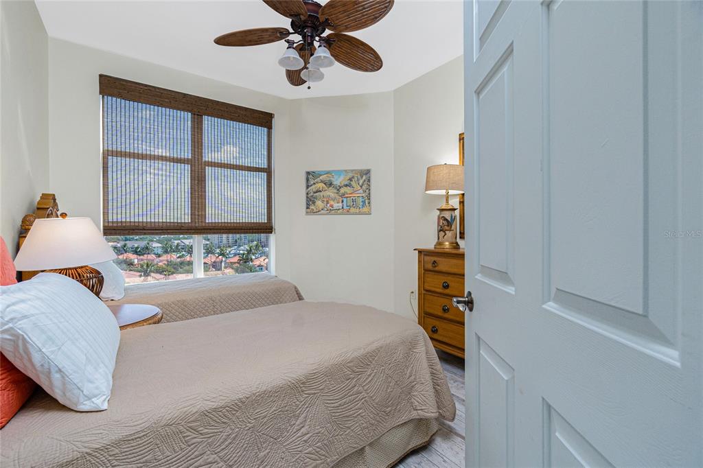 3313 Sunset Key Circle, Unit 701 Punta Gorda, FL 33955 - Photo 30 of 57 a bedroom with a large bed and a chandelier