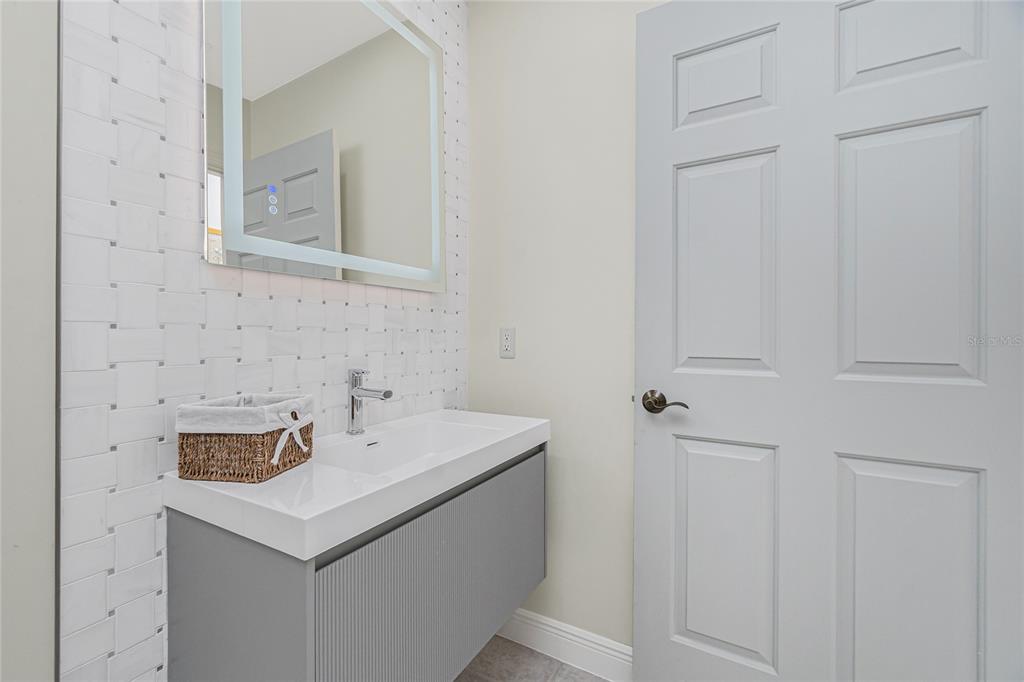 3313 Sunset Key Circle, Unit 701 Punta Gorda, FL 33955 - Photo 35 of 57 a bathroom with a sink and a mirror