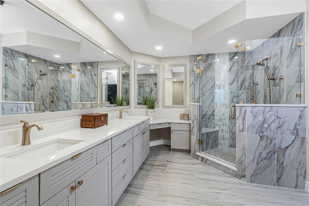 3313 Sunset Key Circle, Unit 701 Punta Gorda, FL 33955 - Photo 44 of 57 a large bathroom with a double vanity sink a mirror and shower