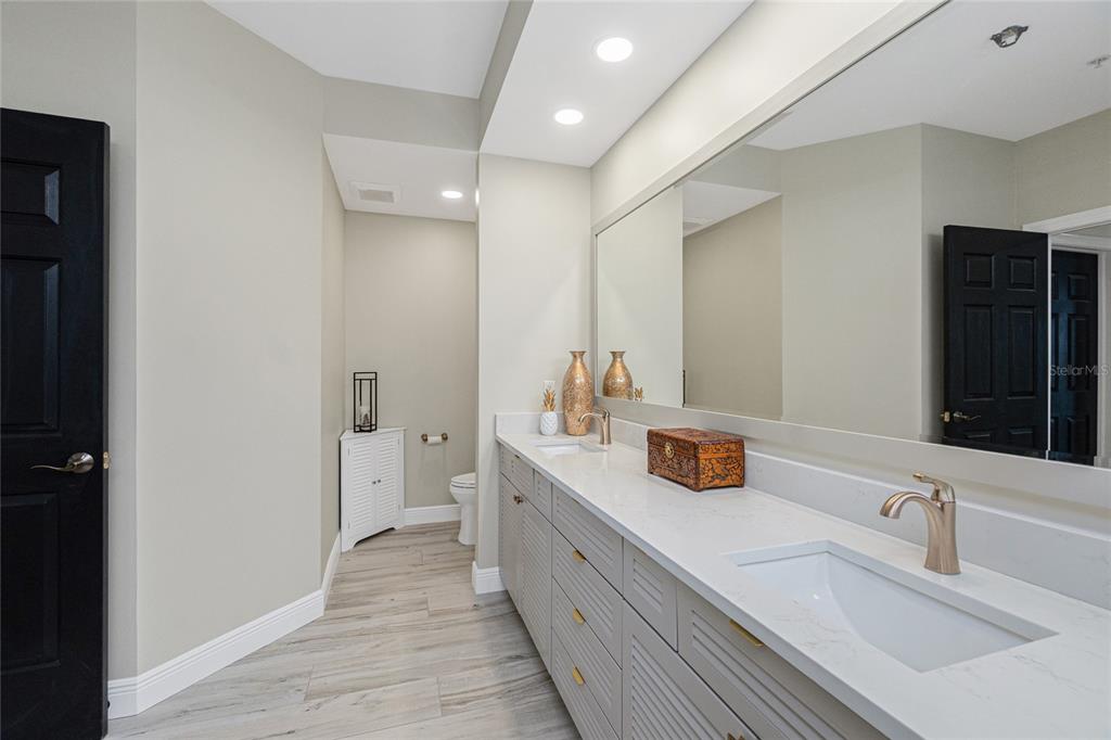 3313 Sunset Key Circle, Unit 701 Punta Gorda, FL 33955 - Photo 46 of 57 a bathroom with a double vanity sink and mirror