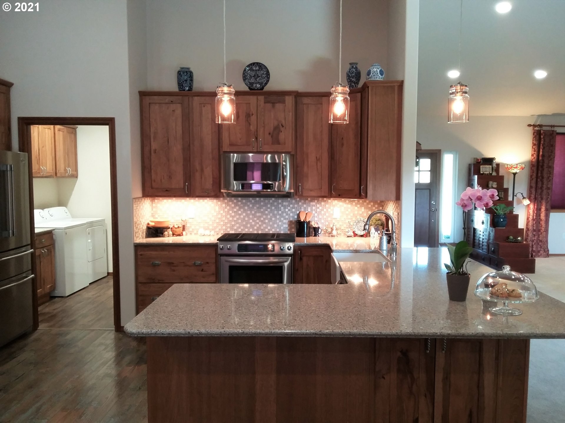 1304 Alpha Court Pendleton, OR 97801 - Photo 21 of 32 a kitchen with stainless steel appliances a sink a stove top oven a counter space and cabinets