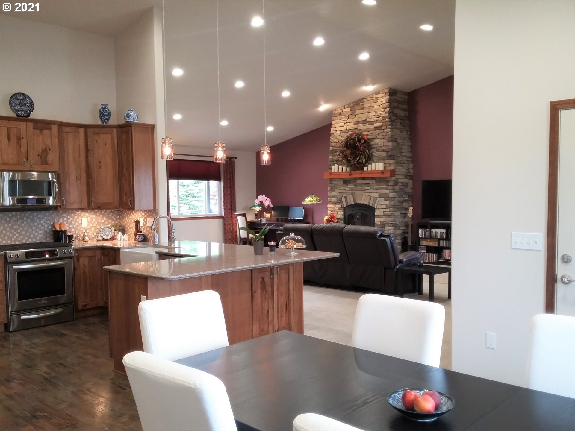 1304 Alpha Court Pendleton, OR 97801 - Photo 10 of 32 a kitchen with stainless steel appliances granite countertop a refrigerator a stove a sink dishwasher a dining table and chairs with wooden floor