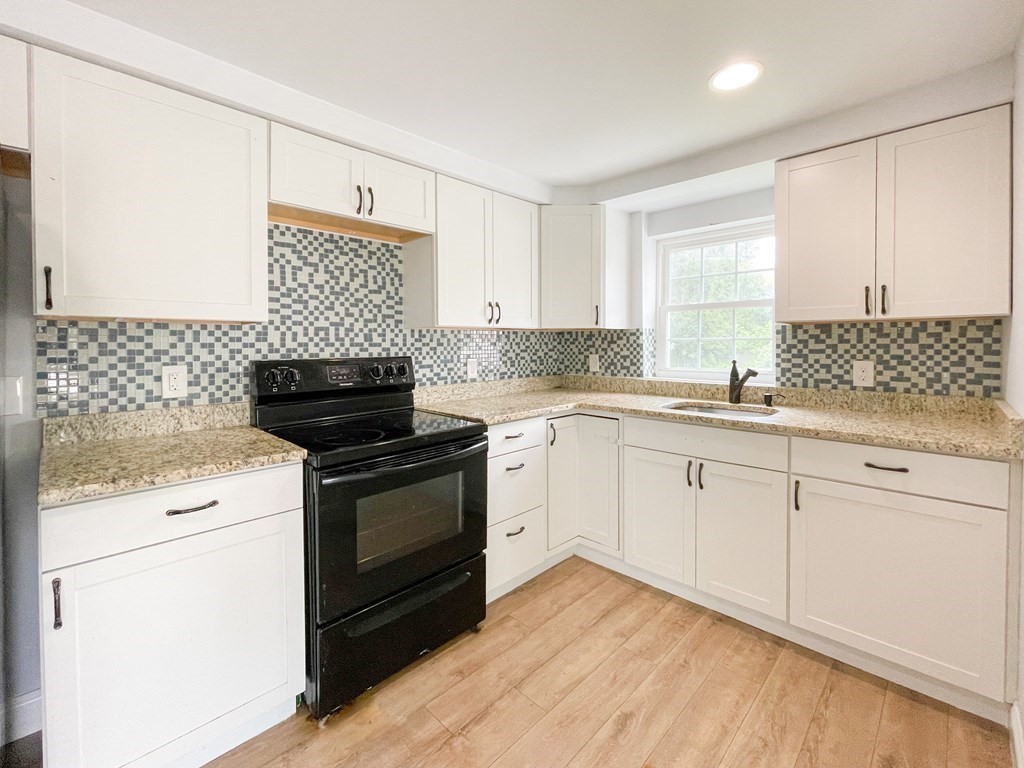 51 School Street North Barre, MA 01005 - Photo 4 of 35 a kitchen with granite countertop white cabinets and white appliances