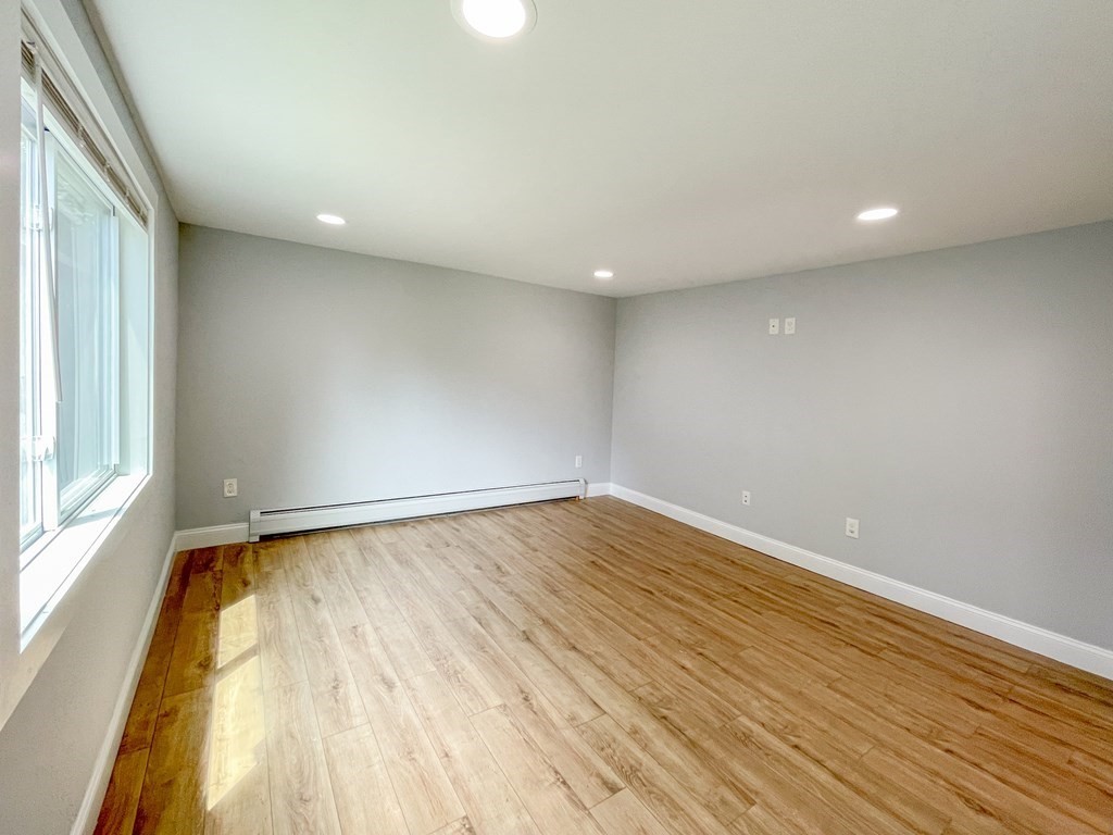51 School Street North Barre, MA 01005 - Photo 10 of 35 a view of an empty room with wooden floor and a window