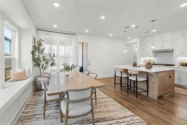 a kitchen with a table and chairs in it