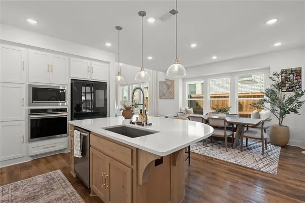 a kitchen with center island table and chairs in it