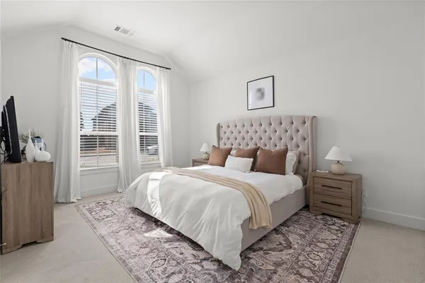a bedroom with a large bed and a window