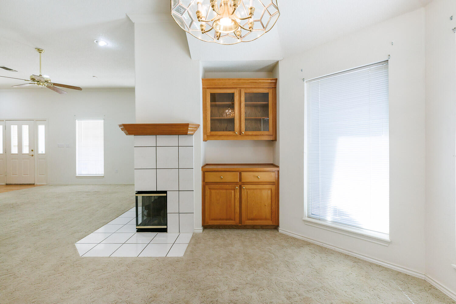 6904 Freeport Avenue Lubbock, TX 79424 - Photo 14 of 49 an empty room with a fireplace and windows
