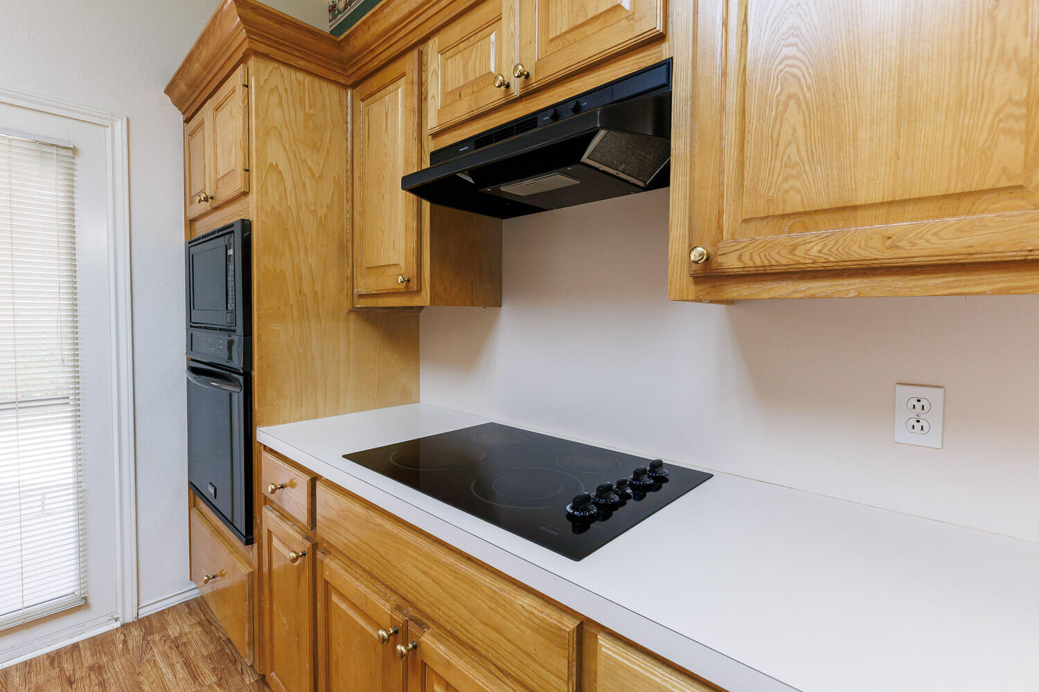 6904 Freeport Avenue Lubbock, TX 79424 - Photo 18 of 49 a kitchen with stainless steel appliances granite countertop white cabinets and a wooden floor
