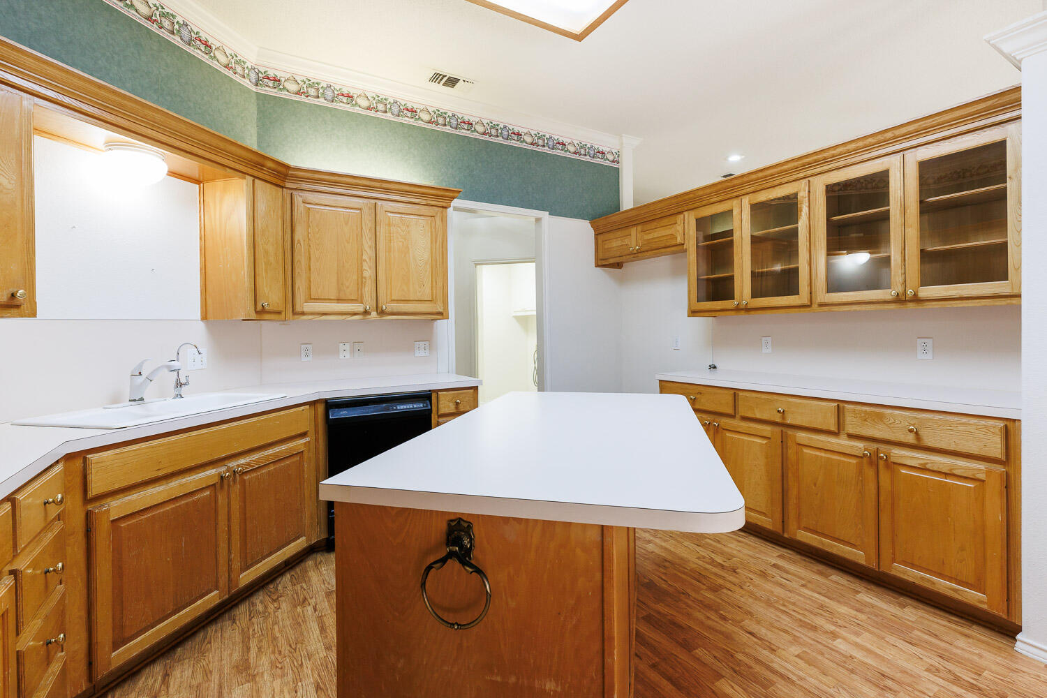 6904 Freeport Avenue Lubbock, TX 79424 - Photo 20 of 49 a kitchen with stainless steel appliances granite countertop a sink a stove and wooden floors