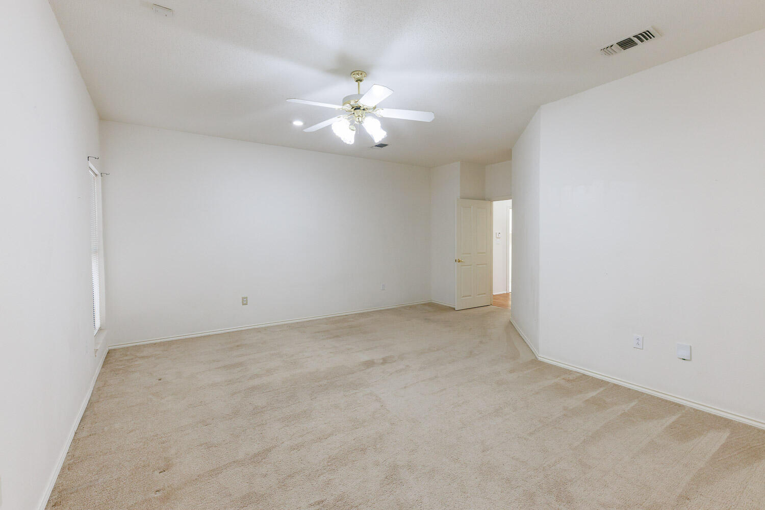 6904 Freeport Avenue Lubbock, TX 79424 - Photo 25 of 49 an empty room with a chandelier fan