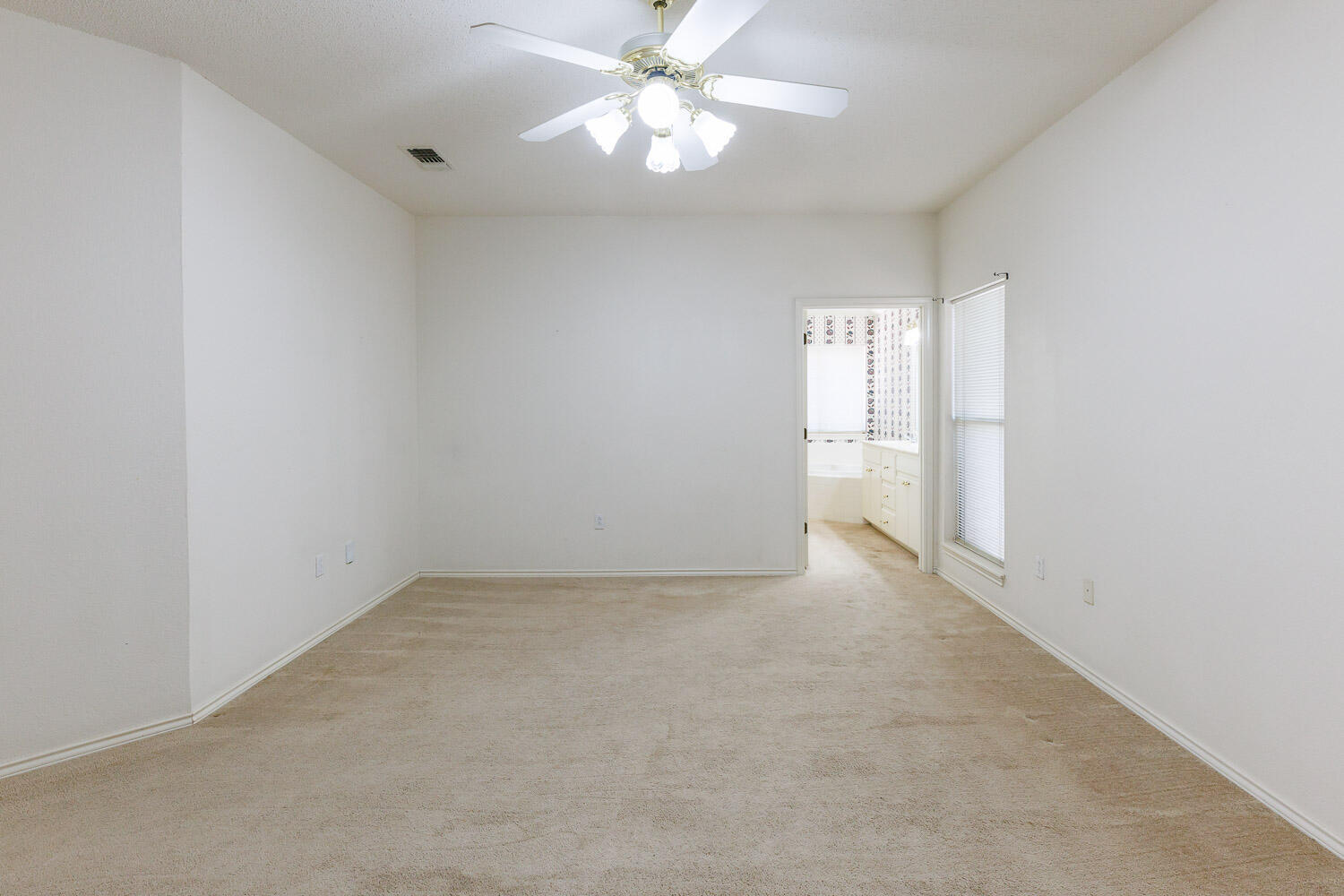 6904 Freeport Avenue Lubbock, TX 79424 - Photo 27 of 49 an empty room with a ceiling fan and a window