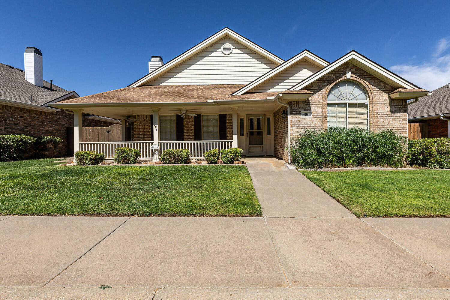 6904 Freeport Avenue Lubbock, TX 79424 - Photo 6 of 49 a front view of a house with a yard and potted plants