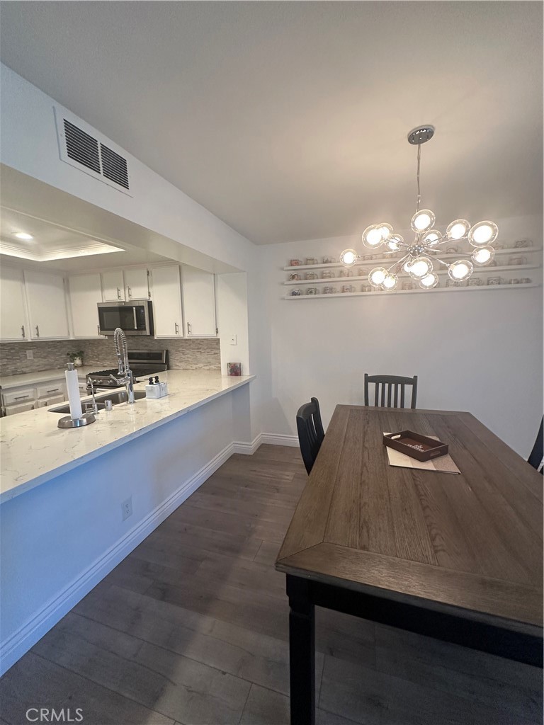 29 Woodleaf Irvine, CA 92614 - Photo 3 of 23 a kitchen with a sink a refrigerator and cabinets