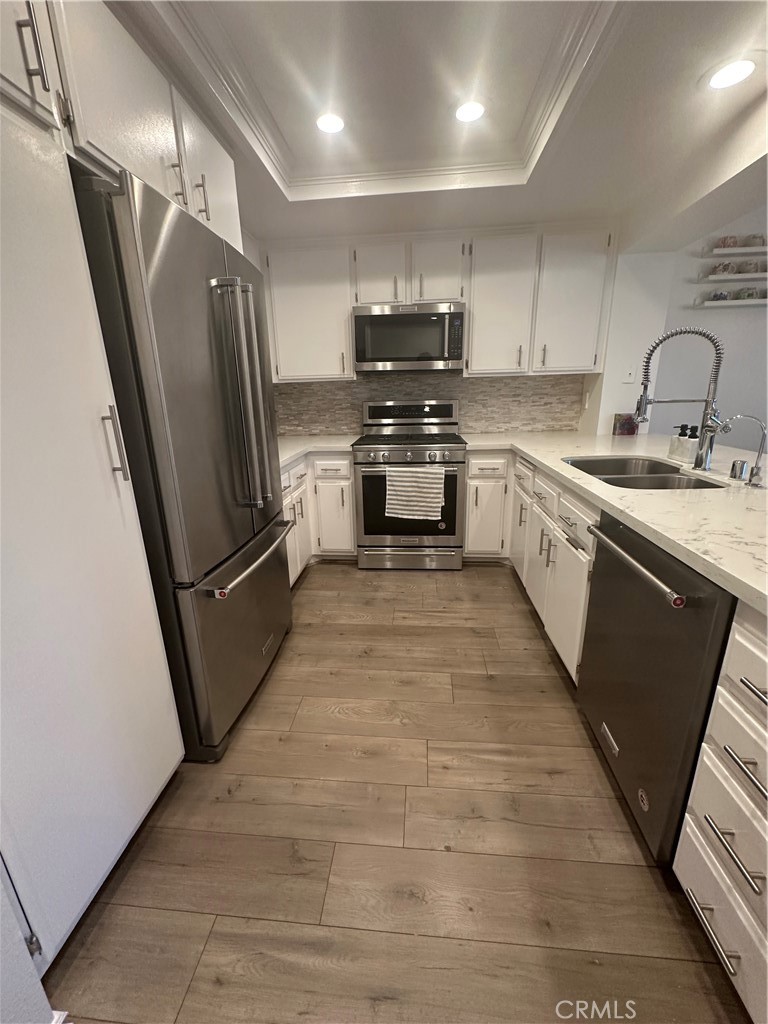29 Woodleaf Irvine, CA 92614 - Photo 10 of 23 a kitchen with granite countertop a refrigerator and a sink