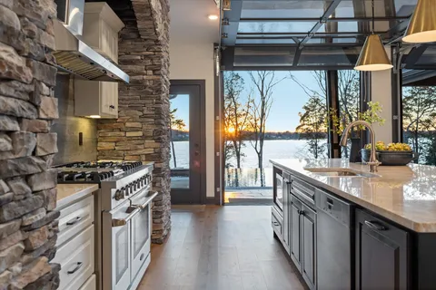 a kitchen with stainless steel appliances granite countertop a stove a sink and a microwave