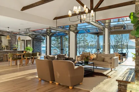 a living room with furniture windows and wooden floor