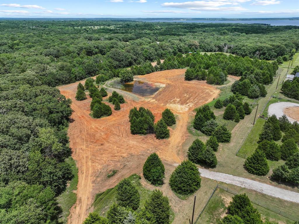 1445 Cedar Mills Road Gordonville, TX 76245 - Photo 1 of 28 Cleared and wooded acreage featuring an on-site pond and established natural landscaping