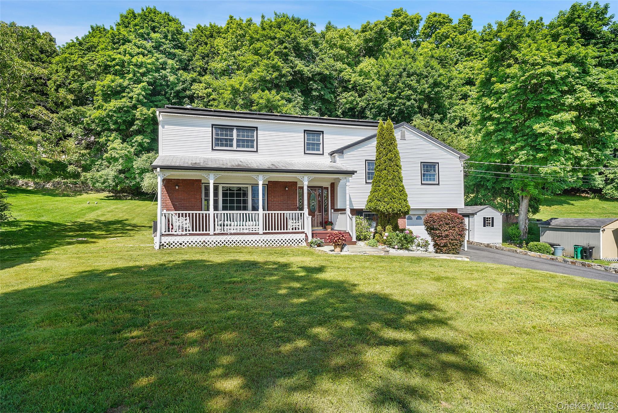 623 Cardinal Road Cortlandt Manor, NY 10567 - Photo 1 of 40 a front view of a house with a garden