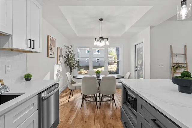 a kitchen with a table chairs stove and cabinets