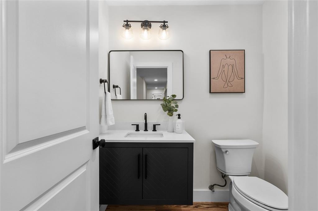 1883 Bennett Ridge Southwest Snellville, GA 30078 - Photo 19 of 56 a bathroom with a toilet sink and mirror