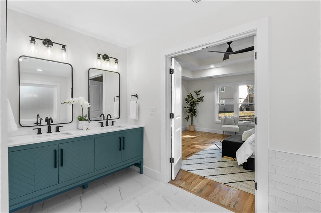 1883 Bennett Ridge Southwest Snellville, GA 30078 - Photo 25 of 56 a en suite bathroom with double vanity sinks and a mirror