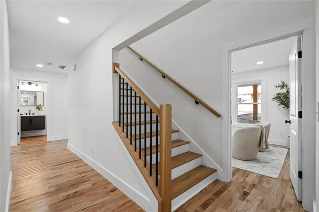 a bathroom with a bathtub sink vanity and mirror