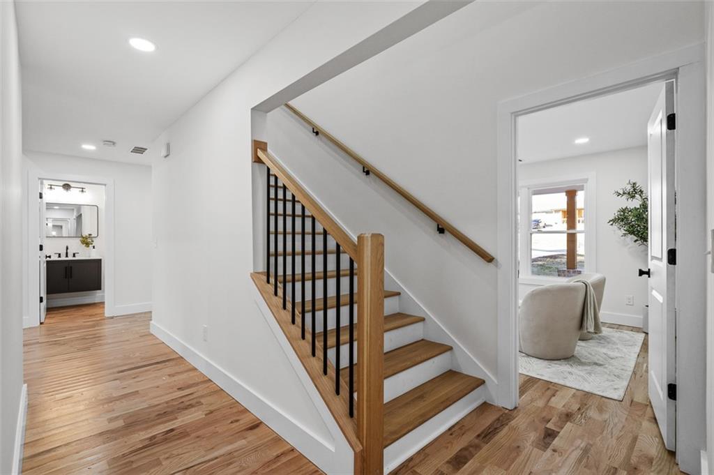 1883 Bennett Ridge Southwest Snellville, GA 30078 - Photo 30 of 56 a view of a hallway with wooden floor and staircase