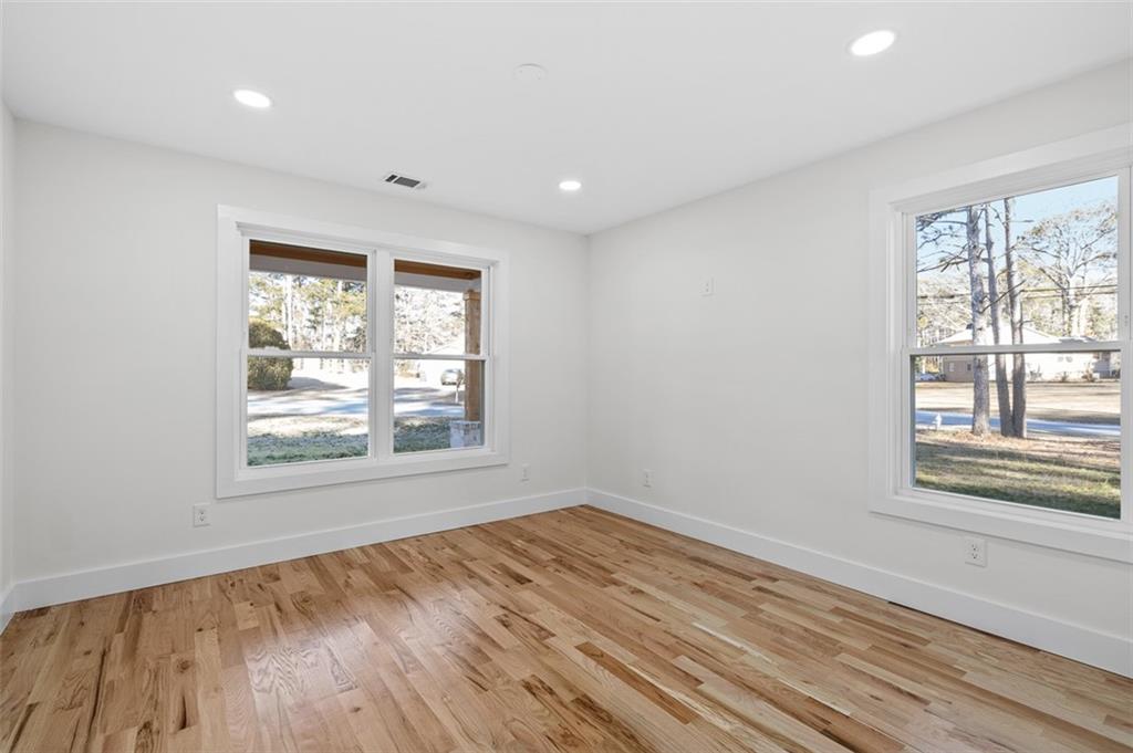 1883 Bennett Ridge Southwest Snellville, GA 30078 - Photo 31 of 56 a view of an empty room with wooden floor and a window