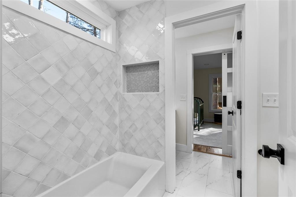 1883 Bennett Ridge Southwest Snellville, GA 30078 - Photo 34 of 56 a bathroom with a bathtub and a shower