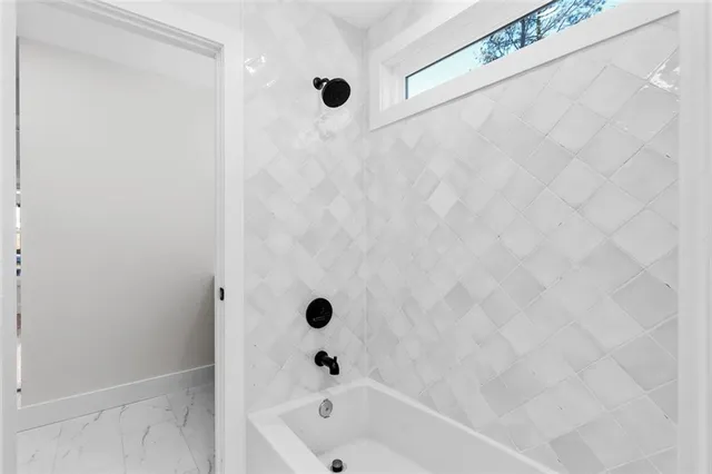 a living room with furniture a table and a potted plant