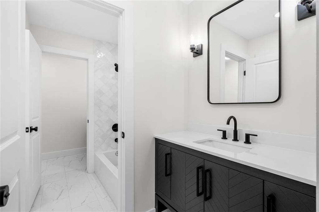 1883 Bennett Ridge Southwest Snellville, GA 30078 - Photo 36 of 56 a bathroom with a sink and mirror