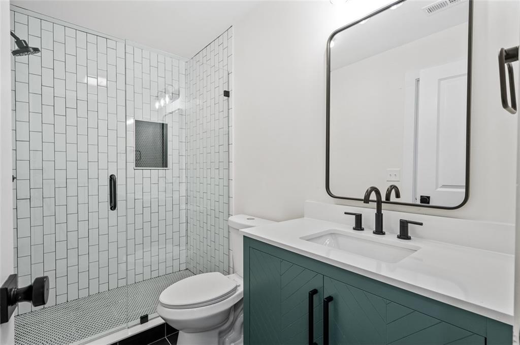 1883 Bennett Ridge Southwest Snellville, GA 30078 - Photo 45 of 56 a bathroom with a sink toilet and shower