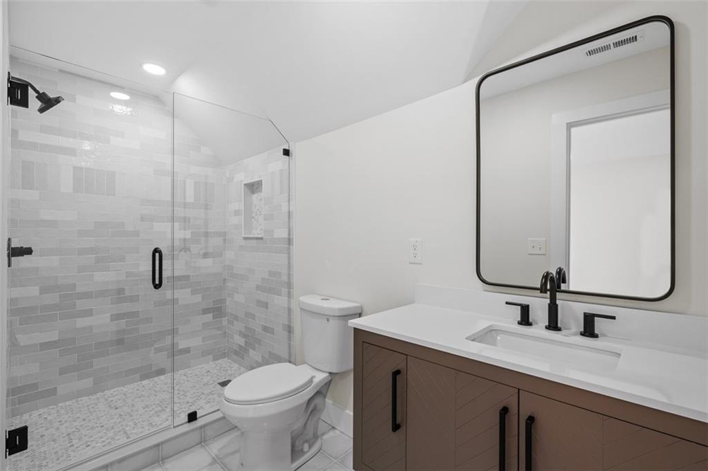 1883 Bennett Ridge Southwest Snellville, GA 30078 - Photo 48 of 56 a bathroom with a sink toilet and shower