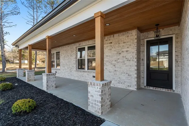 a view of a hallway view with wooden floor and staircase