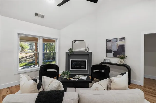 a living room with furniture a fireplace and a flat screen tv