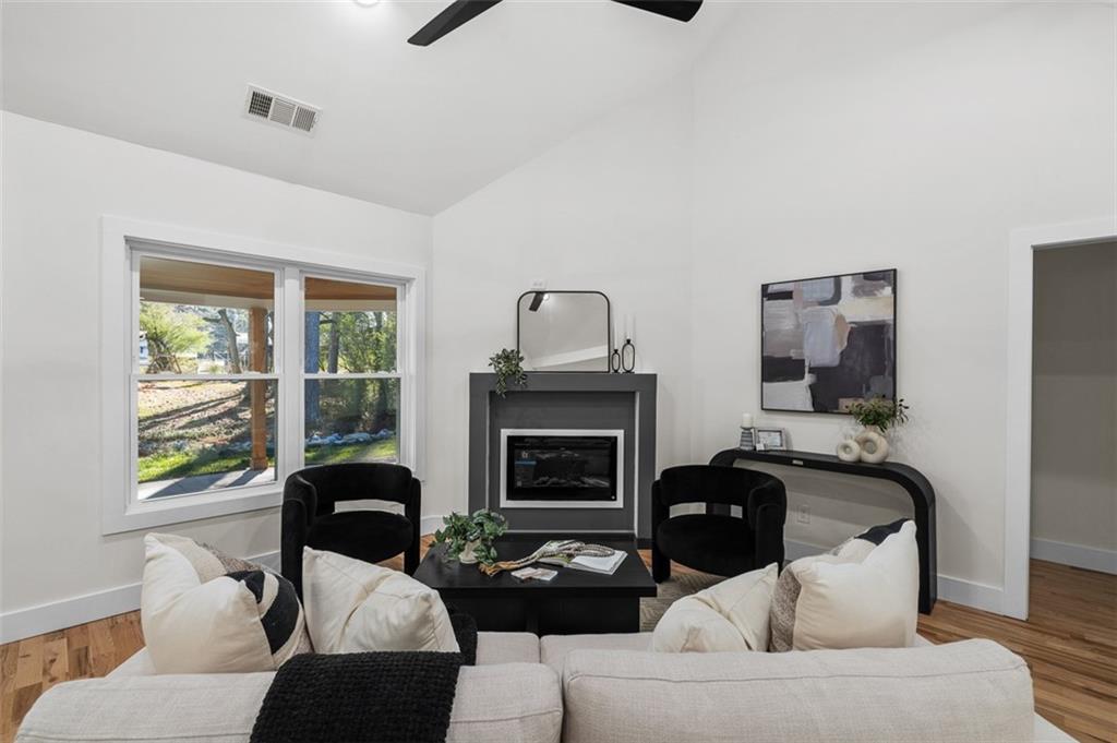1883 Bennett Ridge Southwest Snellville, GA 30078 - Photo 8 of 56 a living room with furniture and a fireplace