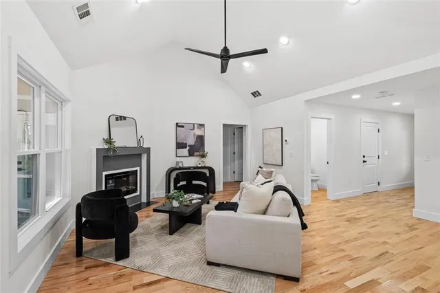 a living room with furniture and a view of kitchen