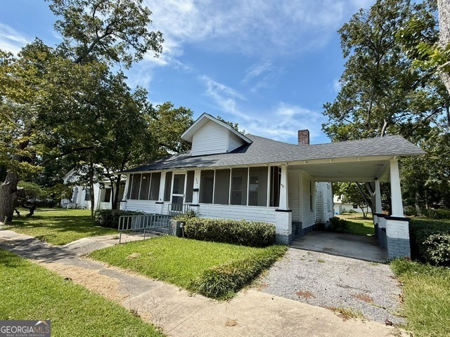 450 South Rountree Street Metter, GA 30439 - Photo 1 of 17 a front view of a house with a garden and trees