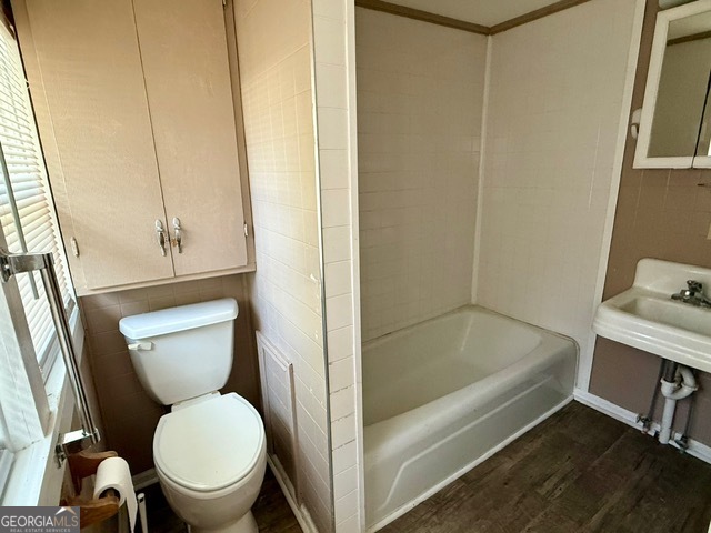 450 South Rountree Street Metter, GA 30439 - Photo 11 of 17 a bathroom with a toilet and a bathtub