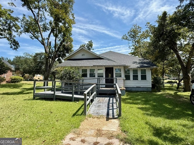 450 South Rountree Street Metter, GA 30439 - Photo 12 of 17 a front view of a house with a yard table and chairs