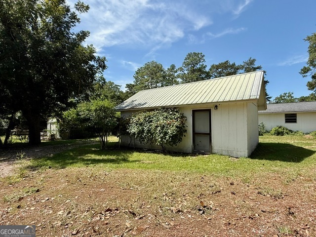 450 South Rountree Street Metter, GA 30439 - Photo 13 of 17 a front view of a house with a yard and garage