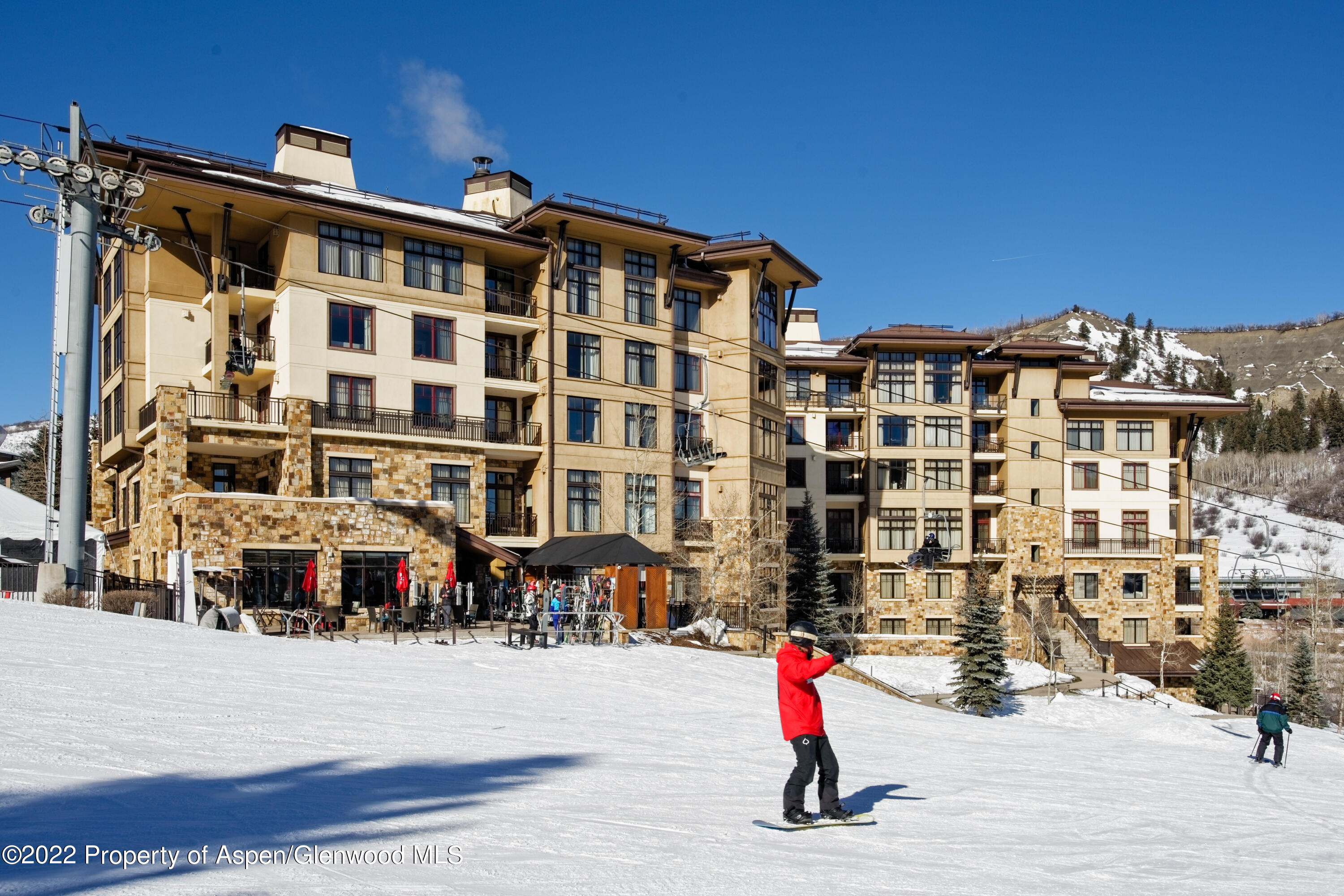130 Wood Road, Unit 505 & 507 Snowmass Village, CO 81615 - Photo 1 of 17 a front view of a building with a street