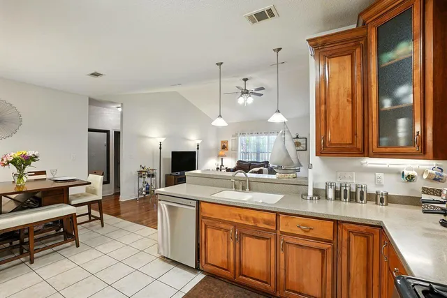 a kitchen with stainless steel appliances a sink stove and cabinets