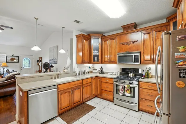 a kitchen with a sink stove top oven and cabinets