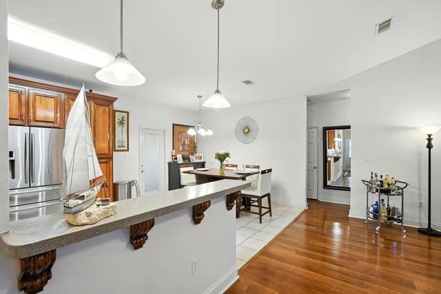 a very nice looking living room with a large window and wooden floor